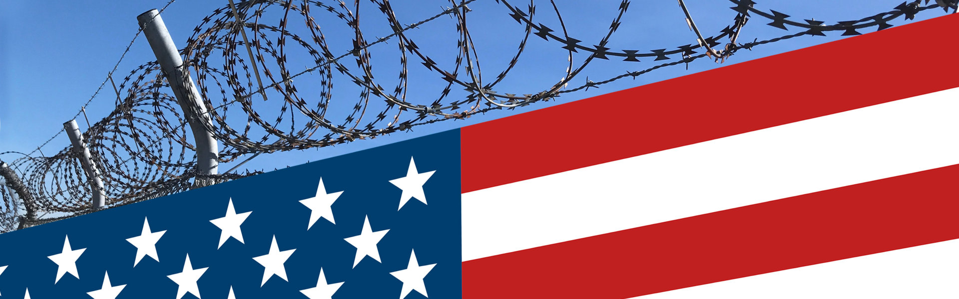 fence with barbed wire and the american flag below